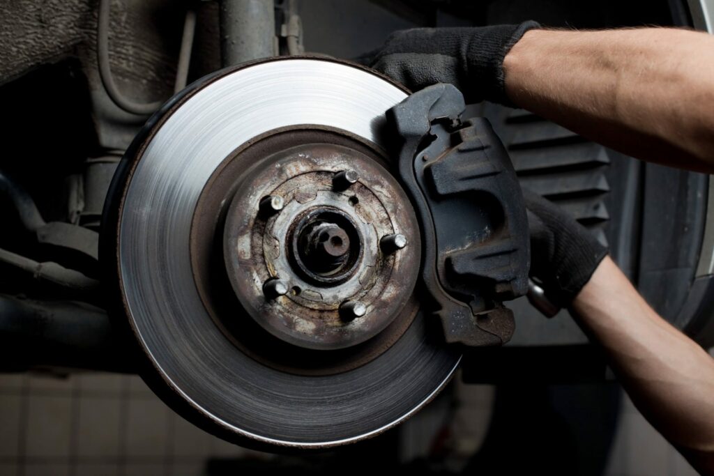 Mechanic working on car brakes