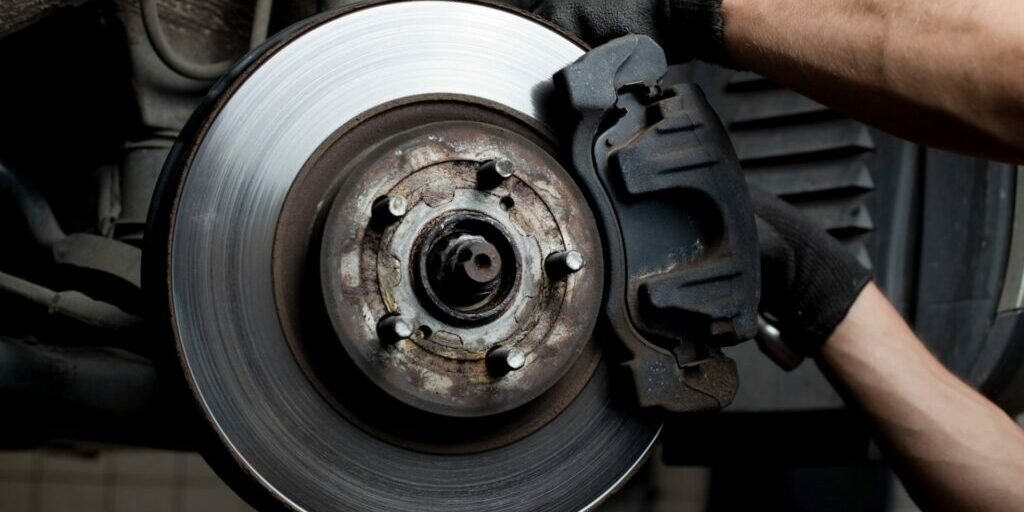 Mechanic working on car brakes