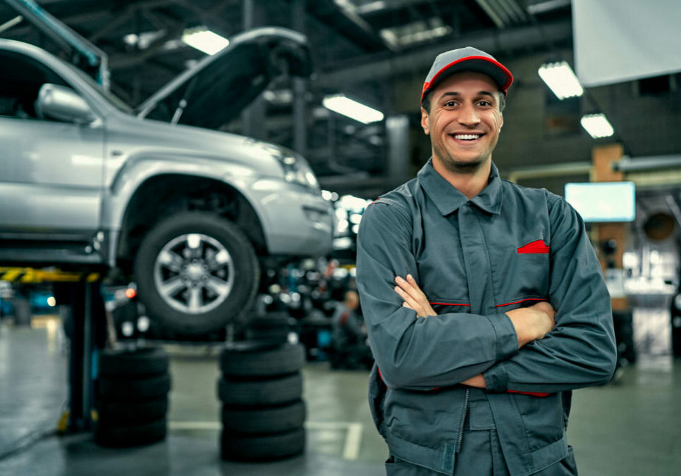 car service technician smiling with arms folded car service technician smiling with arms folded